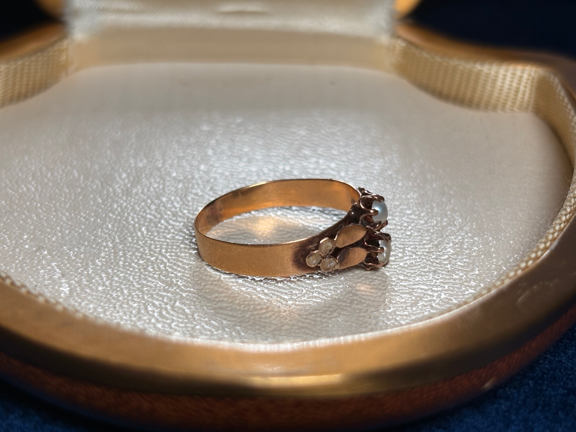 Gold ring with a pearl in an open jewelry box
